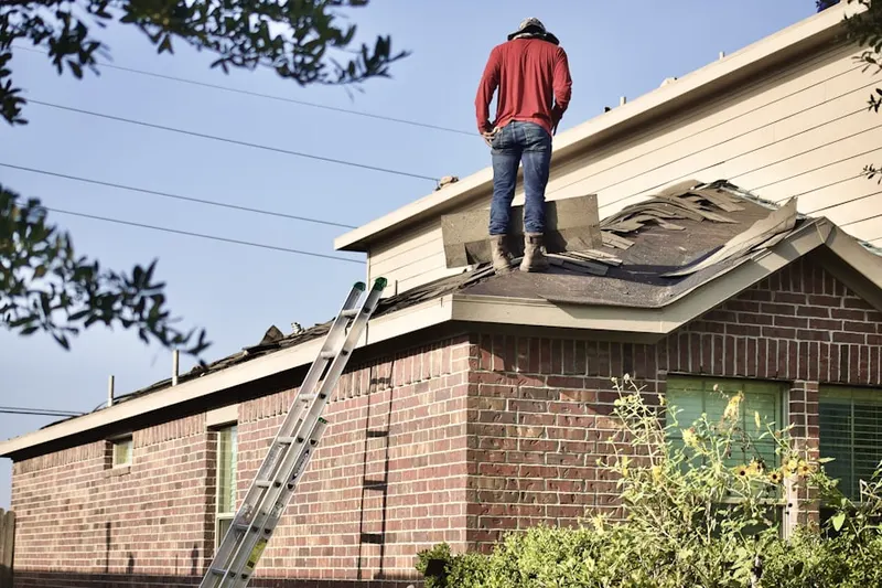 Professional roofer working on a residential roof in Flying S Ranchettes